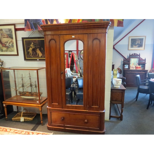 1056 - A Victorian mahogany wardrobe, the central arched mirrored door over a single drawer to plinth base,... 