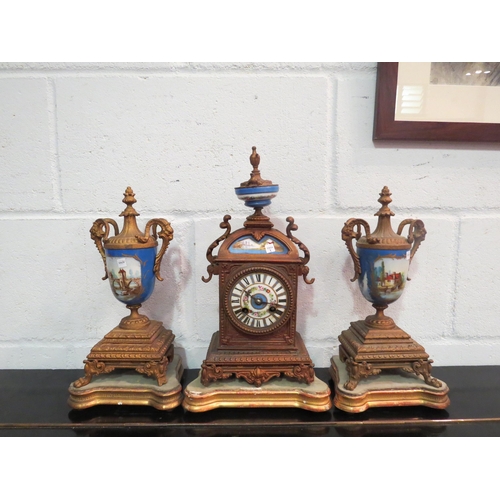 1062 - A French clock garniture, circa 1860, gilt metal with painted porcelain panel, with two side pieces ... 