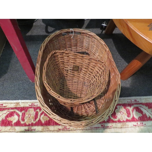 1160 - A twin handled wicker basket of oval form, 54cm long and a wicker bicycle basket (2)