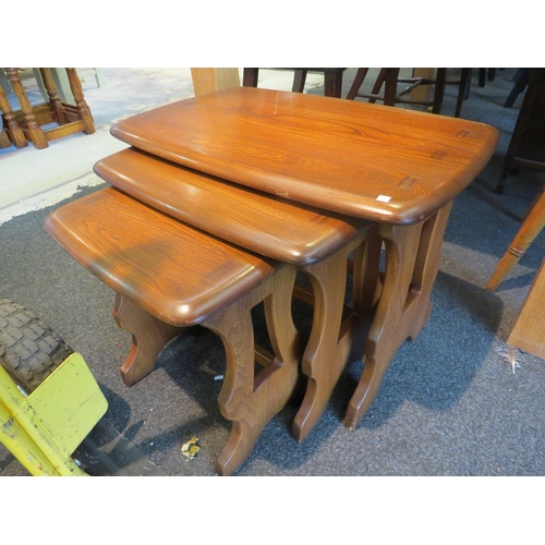 1176 - A nest of three Ercol tables, largest 42cm tall x 57cm long x 35cm wide