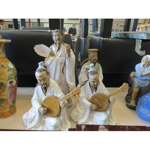 1189 - Four 20th Century Oriental ceramic figures one holding feathered fan a/f, two seated playing musical... 