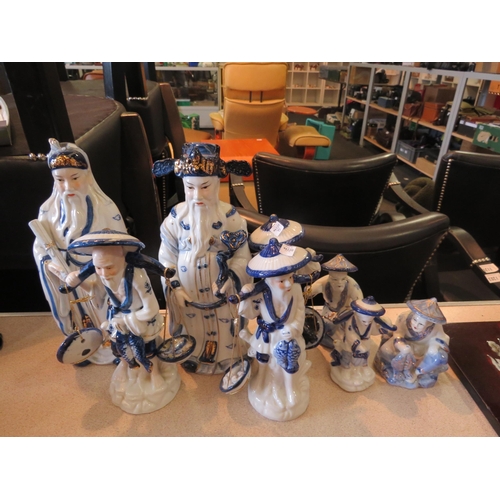 1192 - A selection of 20th Century blue and white ceramic Oriental figures to include fish sellers, etc.  (... 