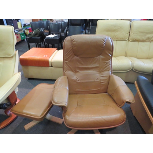 1209 - A tan leather Stressless style swivel armchair with matching footstool