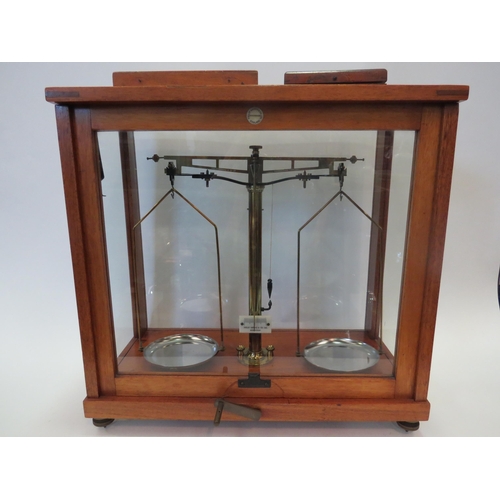 1261 - A Philip Harris and Co. set of scientific scales in glass case with boxed weights