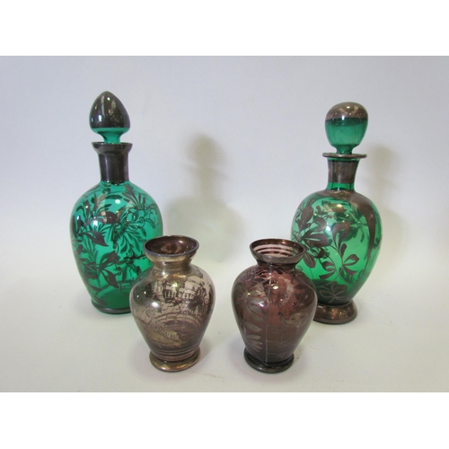 1323 - A pair of green glass silver overlay miniature decanters with stoppers and a pair of similar vases, ... 