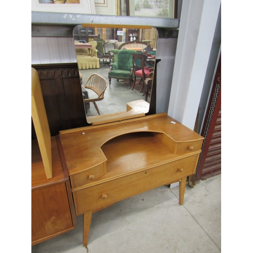 2427 - A 1960's oak dressing chest, the mirror back over alcove flanked by twin drawers, over single long d... 