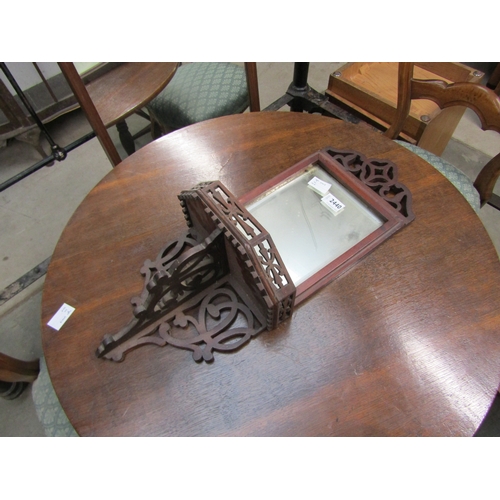 2440 - An Edwardian mahogany Gothic glazed wall mirror with shelf