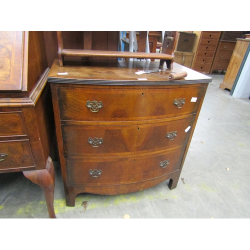 2473 - A Georgian style walnut chest of three bow fronted drawers        (E) £20-30