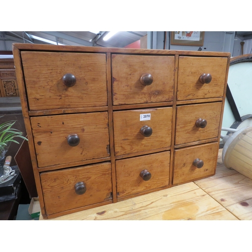 2070 - A Victorian waxed pine bank of nine drawers 71cm x 52cm x 23cm deep