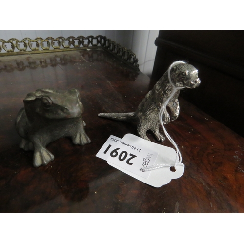 2091 - A small metal otter and frog figure signed T. Earl