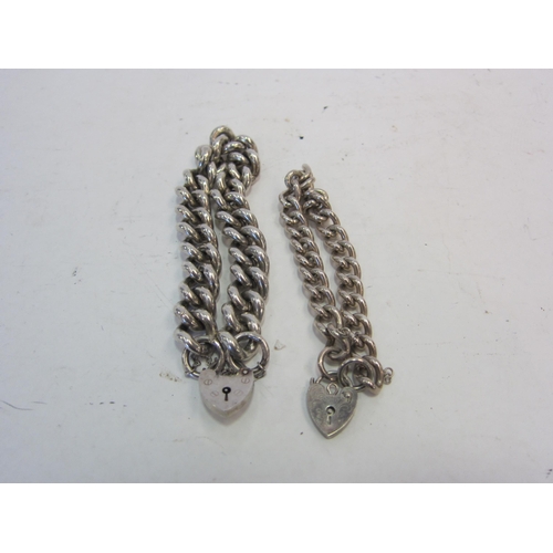 1386 - Two curb link bracelets with silver padlock form clasps.  116g