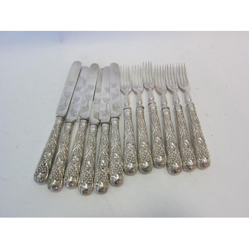 1394 - A set of six ornate embossed fruit knives and forks