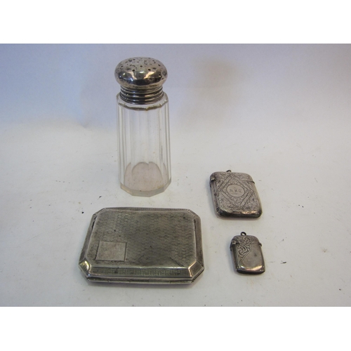 1398 - A silver cigarette case, two silver vesta cases and a silver topped sugar caster