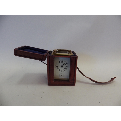 1401 - An early 20th Century French brass carriage clock in original carry case with key.  Face with crack,... 