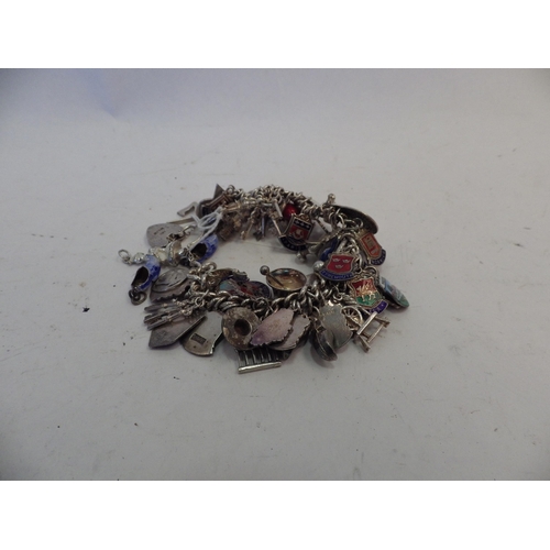 1402 - A silver charm bracelet with multiple charms