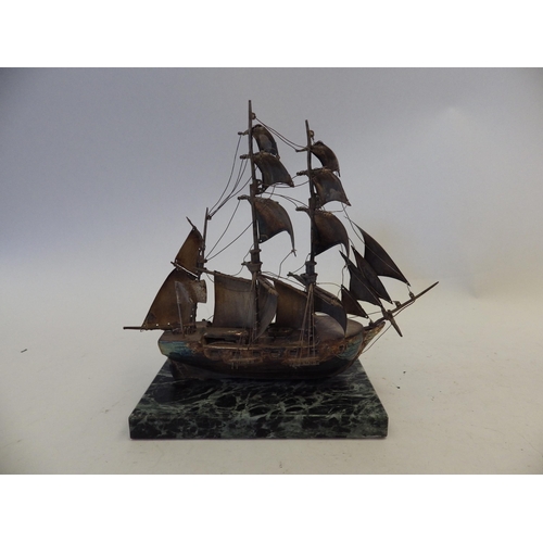 1442 - A white metal figure of a tall ship in full sail, on marble plinth base, total height 17cm