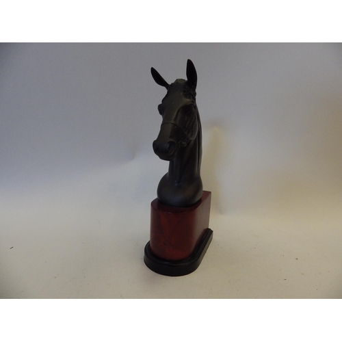 1450 - A pair of metal horse head book-ends on faux mahogany bases, 30.5cm tall