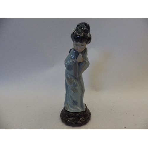 1451 - A Lladro figure of an Oriental girl, missing flower to her hair, 27cm tall