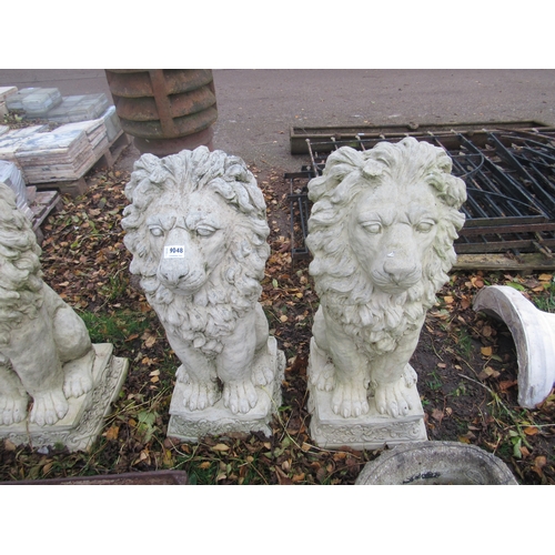 9048 - A pair of composition seated lions, 30