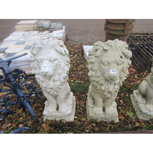 9049 - A pair of composition seated lions, 30