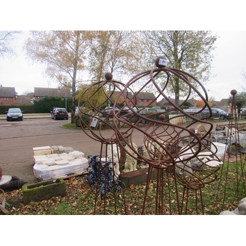 9071 - A pair of steel rust finish decorative orb top obelisks