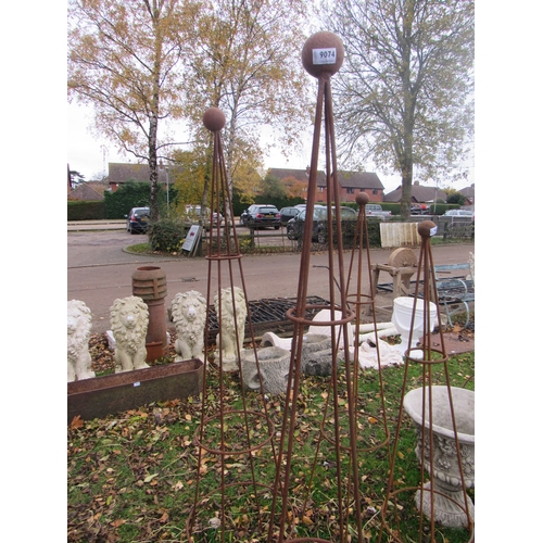 9074 - A pair of steel rust finish ball top obelisks