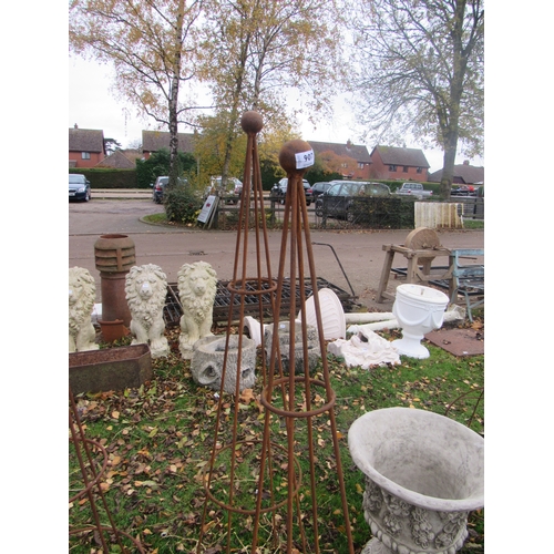 9075 - A pair of steel rust finish ball top obelisks