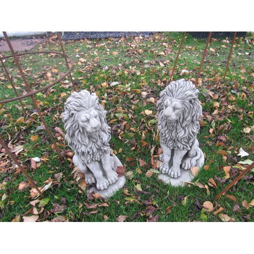 9082 - A pair of composition seated lions, 15