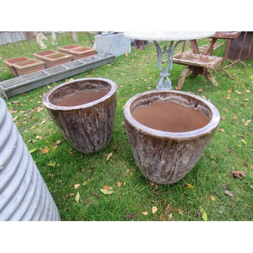 9173 - A pair of brown glazed tapered pots, 19