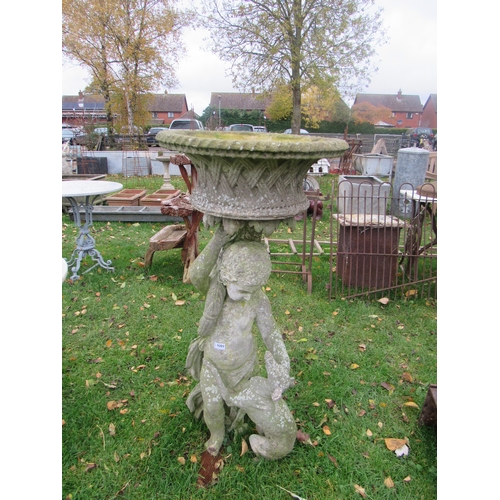 9202 - A composition cherub and dog holding aloft a basketweave planter, 45