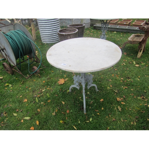 9203 - A cast iron tripod table base with circular marble top, 27