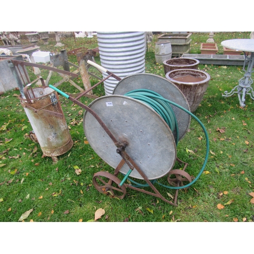 9205 - A large galvanised hose reel on wrought iron trolley frame, with hose