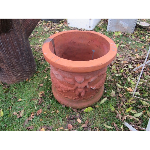 9219 - A circular planter with relief cherub detail, 16