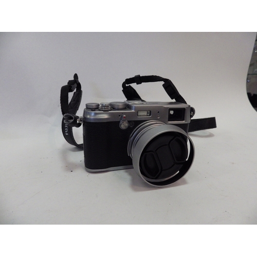 5007 - A Fujifilm X100S digital camera with a 23mm lens and battery charger
