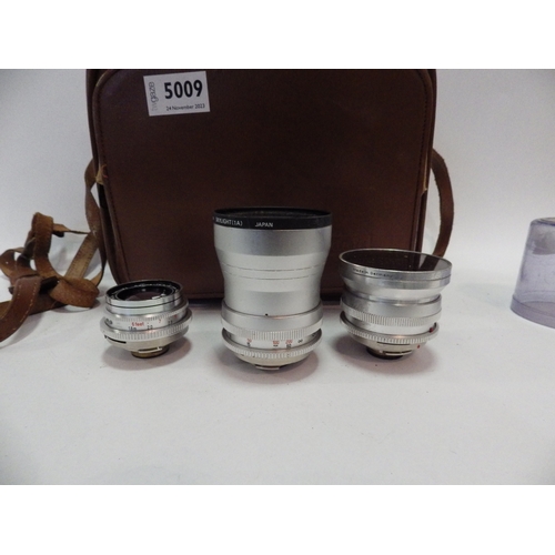 5009 - A Kodak Retina Reflex III camera with a 50mm, 85mm, 135mm and 28mm Schneider-Kreuznach lenses, cased