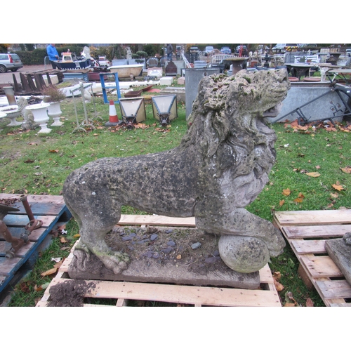 9488 - A pair of weathered composition standing lions, the front paw raised on ball, 41