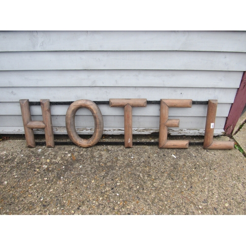 9495 - A wooden 'Hotel' sign on iron frame