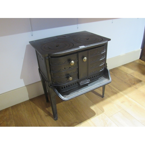 9498 - A cast iron footed oven with brass handles  (R)  £50