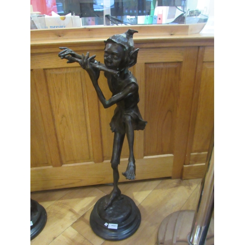 9501 - A bronze figure of an elf playing the flute, 32