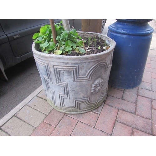 9504 - A pair of circular lead planters with geometric detail and lion masks, some cracking, 15