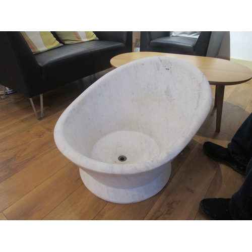 9505 - A white marble shaped hip bath with bronze drainer