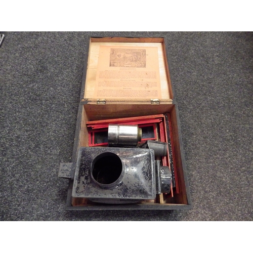 5070 - A Victorian child's magic lantern in the original wooden box with slides