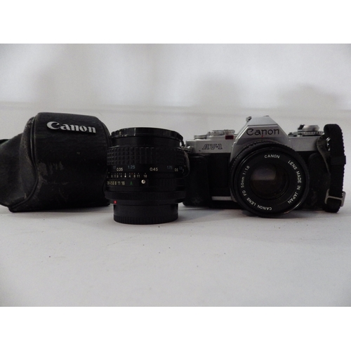 5032 - A canon AV-1 35mm film camera and additional lenses