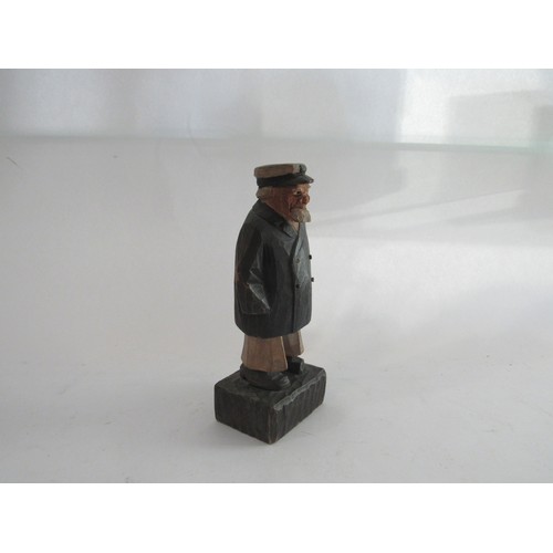 1448 - Carl Johan-Trygg (1887-1954) A hand carved figure of a man dressed in a hat and overcoat signed to b... 