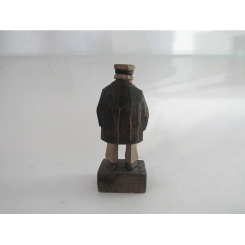 1448 - Carl Johan-Trygg (1887-1954) A hand carved figure of a man dressed in a hat and overcoat signed to b... 