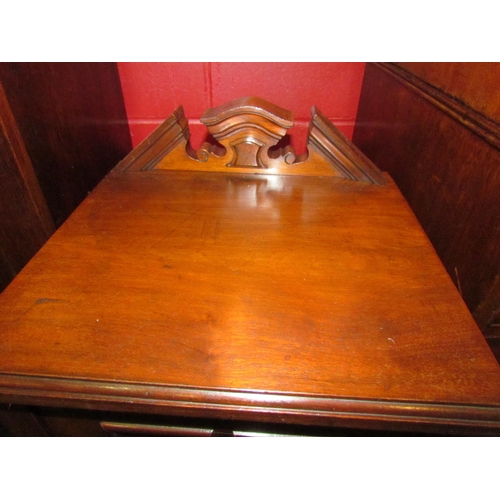 4125 - A late Victorian walnut bedside cabinet with raised arch back over a single door with turned brass h... 