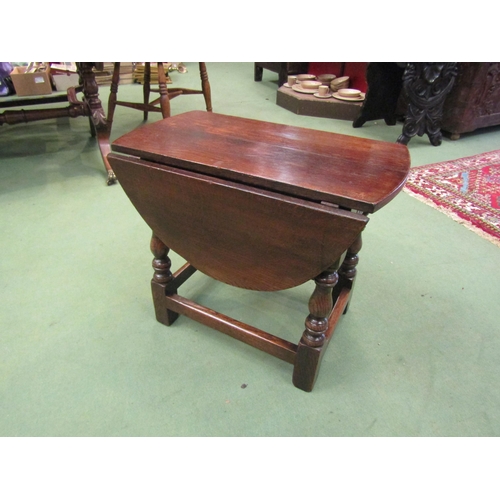 4204 - A 17th Century style pegged oak oval top occasional table/stool, the rising leaves over carved friez... 