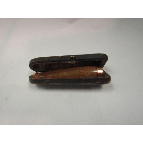 4397 - An amber cheroot holder with a 9ct gold rim, original case (case a/f)