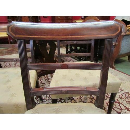 4065 - A set of four George III mahogany dining chairs with crossbanded inlay and reeded backrest over turn... 