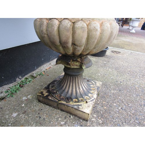 9507 - A pair of J.M. Blashfield, Millwall & Paddington urns on socles, fruit swag moulding to bodies, some... 